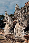 Chiang Mai - The Wat Chedi Luang. The massive chedi heavily damaged by an earthquake. The four staircases are protected by recentely restored guardian naga. 